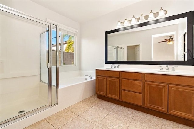 bathroom featuring vanity, shower with separate bathtub, and tile patterned flooring