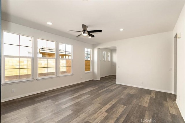 spare room featuring ceiling fan and dark hardwood / wood-style flooring