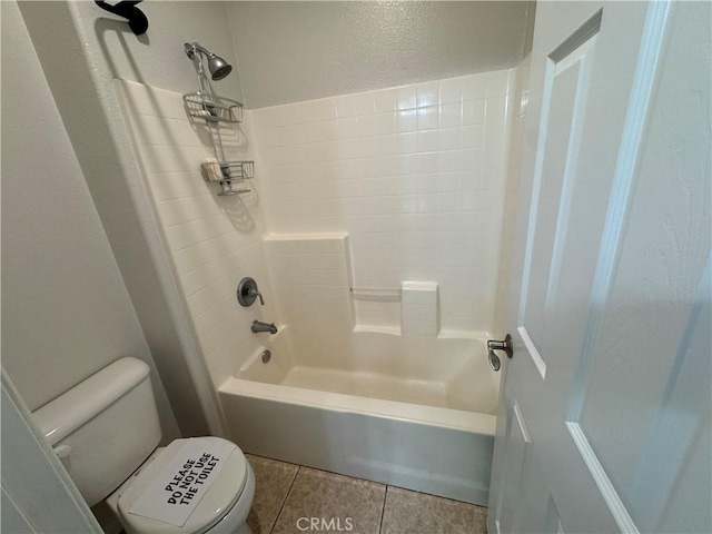 bathroom featuring tile patterned flooring, tub / shower combination, and toilet