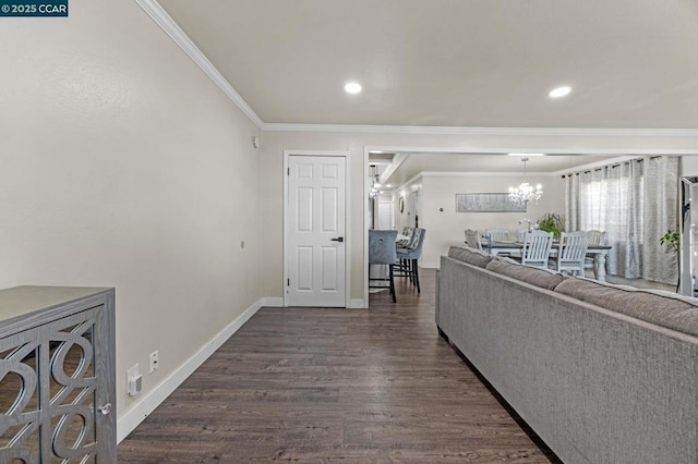 living room with crown molding, an inviting chandelier, and dark wood-type flooring