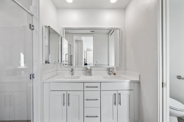 bathroom with vanity, an enclosed shower, and toilet