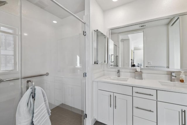 bathroom featuring vanity and a shower with shower door