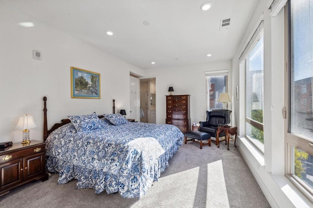 bedroom with multiple windows, light carpet, and access to outside