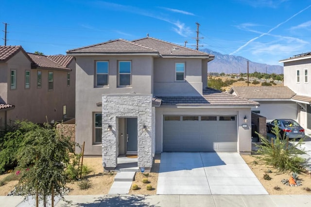 view of front of property featuring a mountain view and a garage