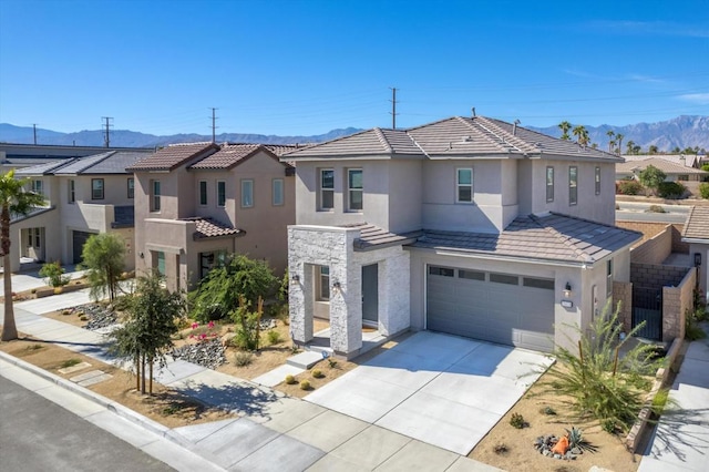 view of front facade featuring a garage and a mountain view