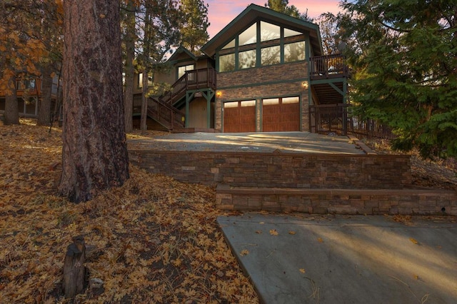 view of front of house with a garage and a wooden deck