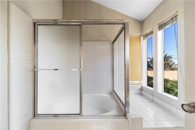 bathroom featuring plus walk in shower and vaulted ceiling