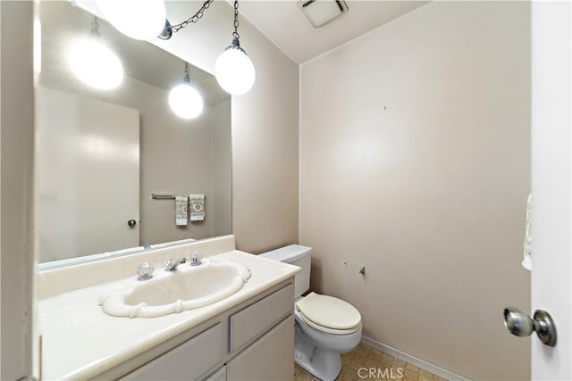 bathroom featuring vanity and toilet