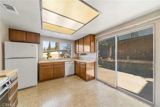 kitchen featuring sink and white appliances