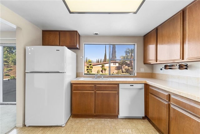 kitchen featuring sink and white appliances