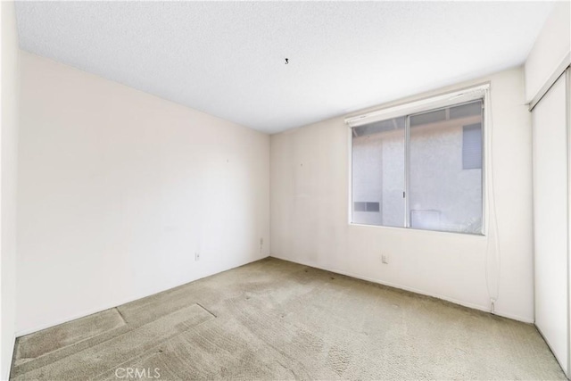 empty room featuring light colored carpet