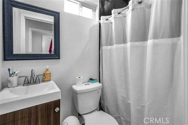 bathroom featuring vanity and toilet