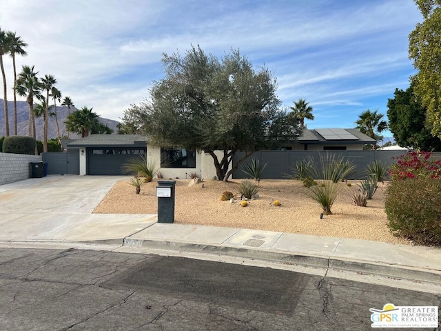 view of front of home with a garage and a mountain view