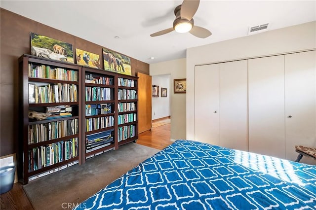 bedroom featuring ceiling fan, a closet, and carpet floors