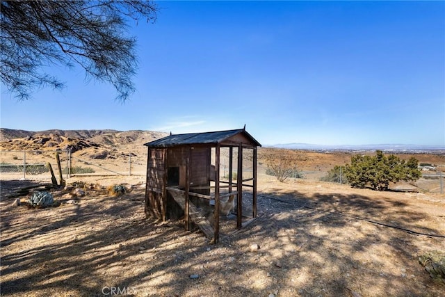 view of outdoor structure featuring a mountain view and a rural view