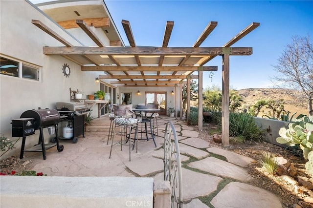 view of patio with a pergola and grilling area