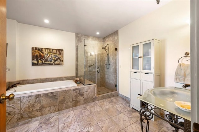 bathroom with separate shower and tub