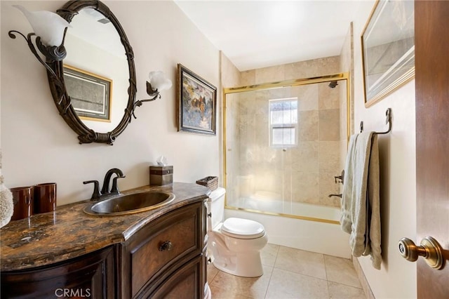 full bathroom featuring tile patterned floors, shower / bath combination with glass door, vanity, and toilet