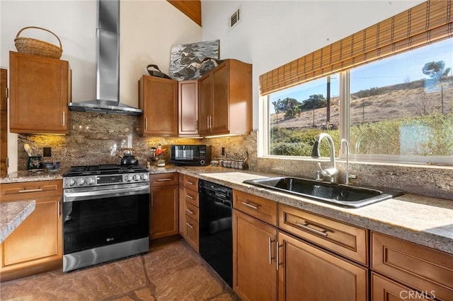 kitchen with black appliances, backsplash, wall chimney range hood, and sink