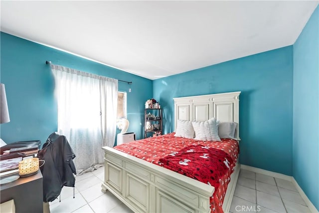 bedroom with light tile patterned floors