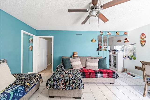 tiled bedroom with a textured ceiling and ceiling fan