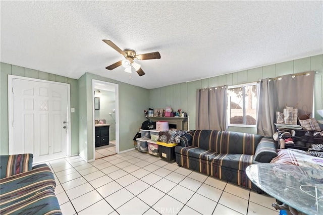 tiled living room featuring ceiling fan and a textured ceiling