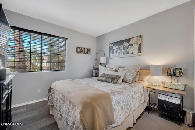 bedroom with dark hardwood / wood-style flooring