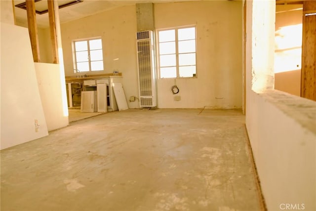 spare room featuring plenty of natural light, sink, and concrete floors