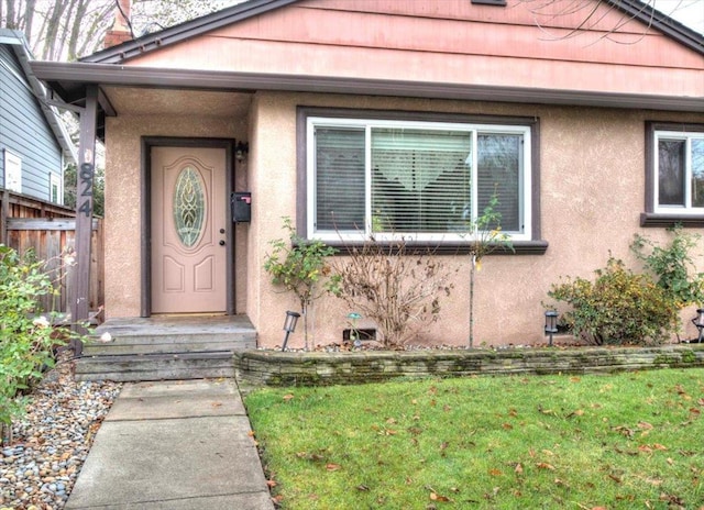 property entrance with a yard