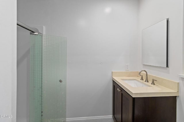 bathroom with vanity and a shower with shower door
