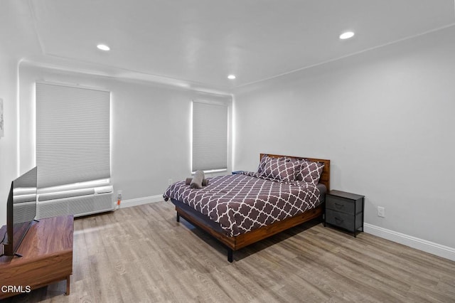bedroom with baseboards, recessed lighting, and wood finished floors