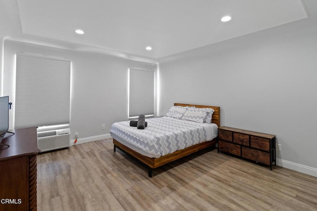 bedroom featuring recessed lighting, baseboards, and light wood-type flooring