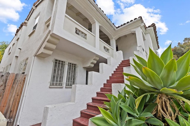 exterior space featuring stairs and fence