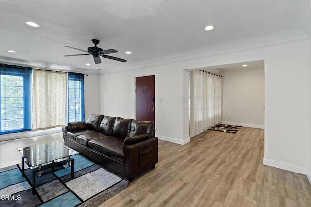 living area featuring recessed lighting, ceiling fan, baseboards, and light wood-style floors