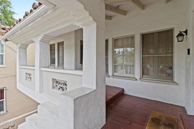 exterior space with covered porch and stucco siding