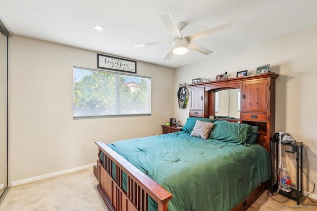 bedroom with ceiling fan and light colored carpet