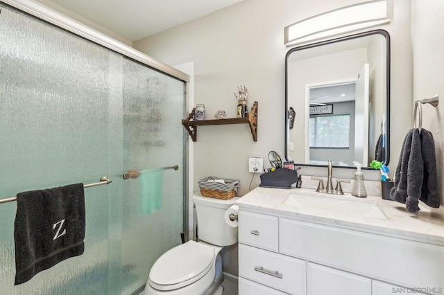 bathroom featuring vanity, toilet, and walk in shower