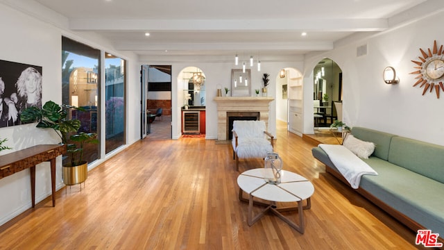 living room with hardwood / wood-style flooring, beamed ceiling, and wine cooler