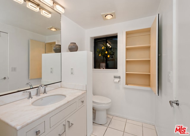 bathroom with tile patterned floors, vanity, and toilet