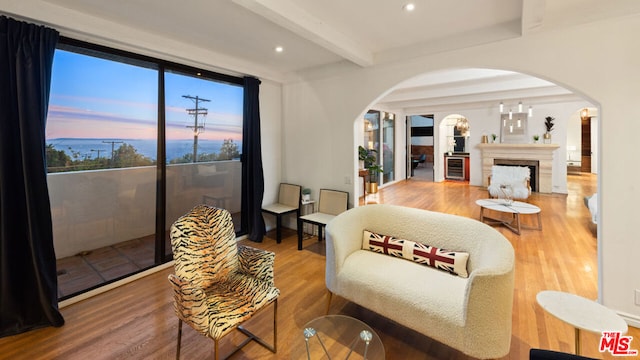 living room with hardwood / wood-style flooring, expansive windows, and beam ceiling