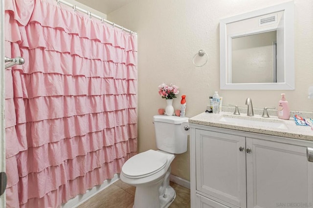 bathroom featuring vanity, toilet, tile patterned floors, and curtained shower