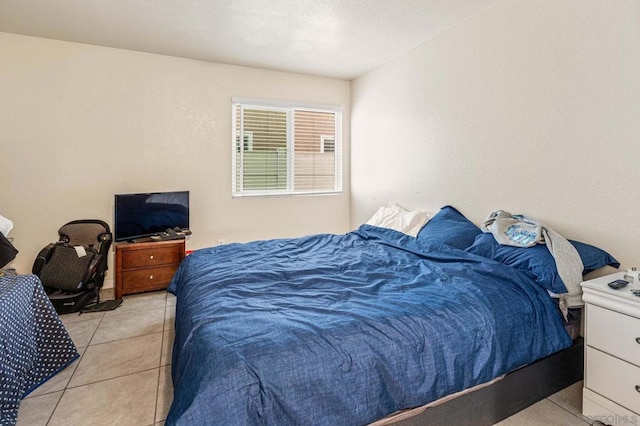 bedroom with light tile patterned floors