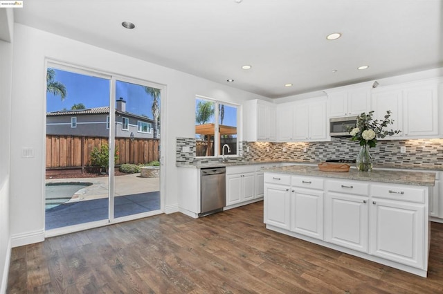 kitchen featuring sink, stainless steel appliances, white cabinetry, and dark wood-type flooring