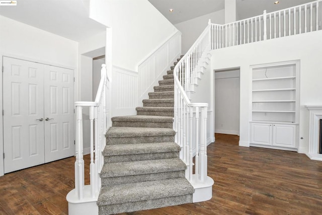 stairs featuring built in features and hardwood / wood-style floors