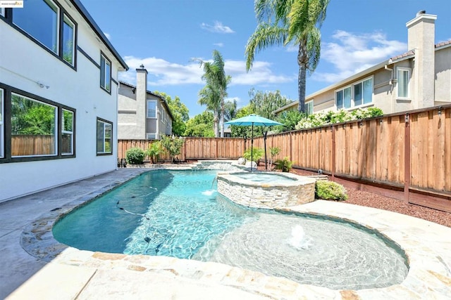 view of swimming pool featuring pool water feature and an in ground hot tub