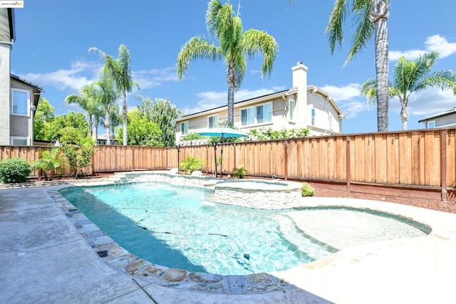 view of pool with an in ground hot tub