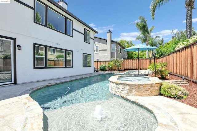 view of swimming pool with an in ground hot tub