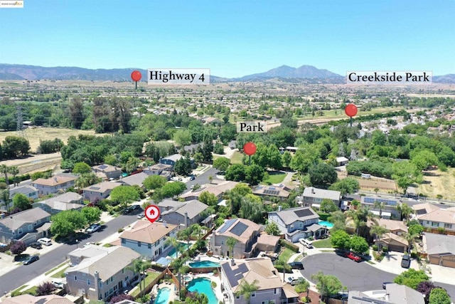 birds eye view of property featuring a mountain view