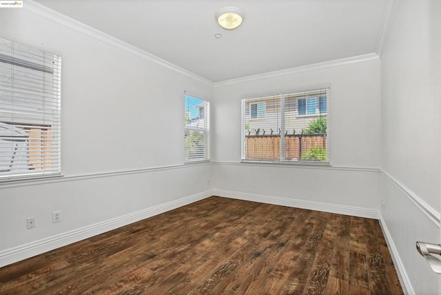 empty room with ornamental molding and dark hardwood / wood-style floors