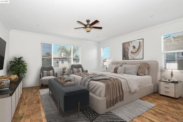 bedroom featuring crown molding, dark hardwood / wood-style floors, and ceiling fan